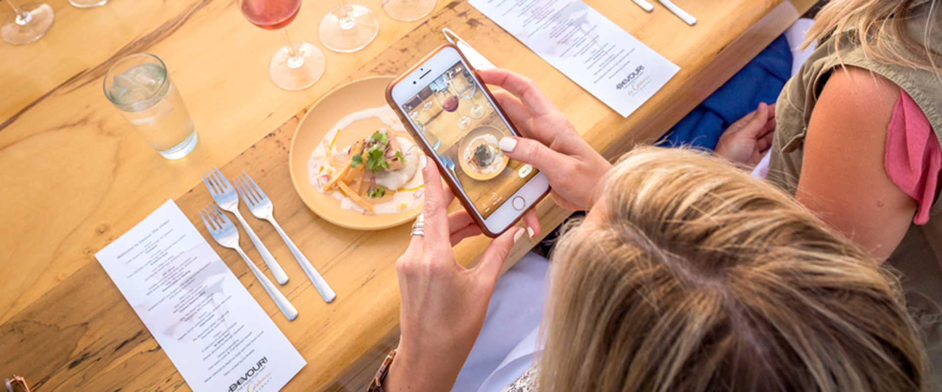 Woman posting an image of her meal on Instagram