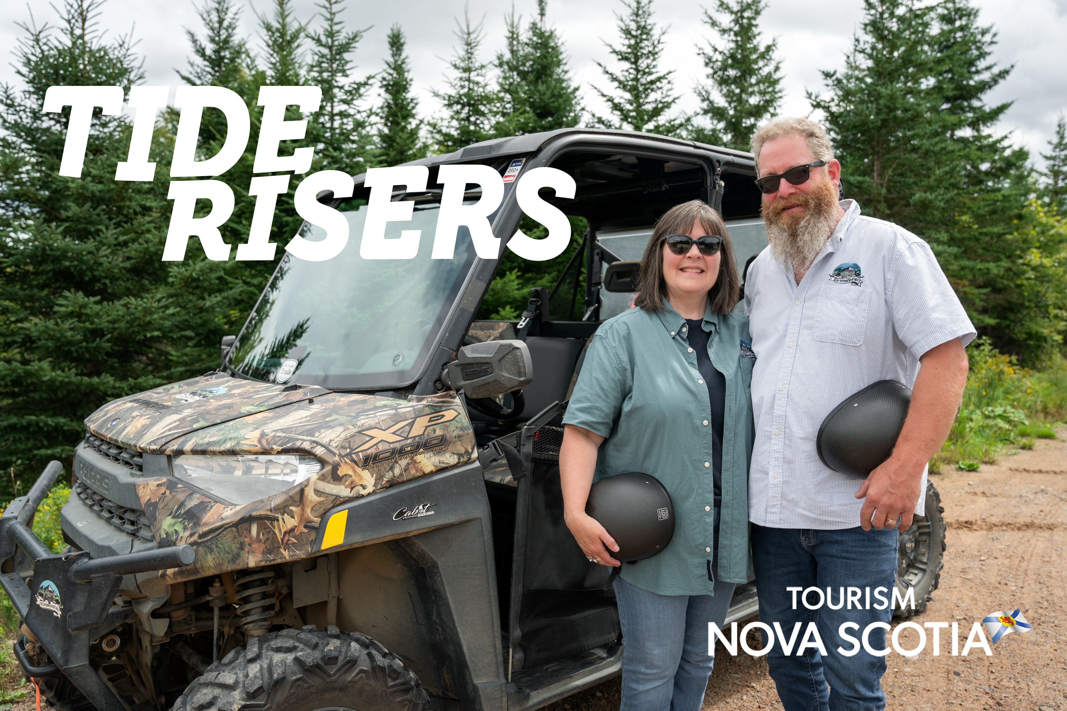 Cathy and Turk Tower standing next to one of their all terrain vehicles at TNT Outdoor Adventures.