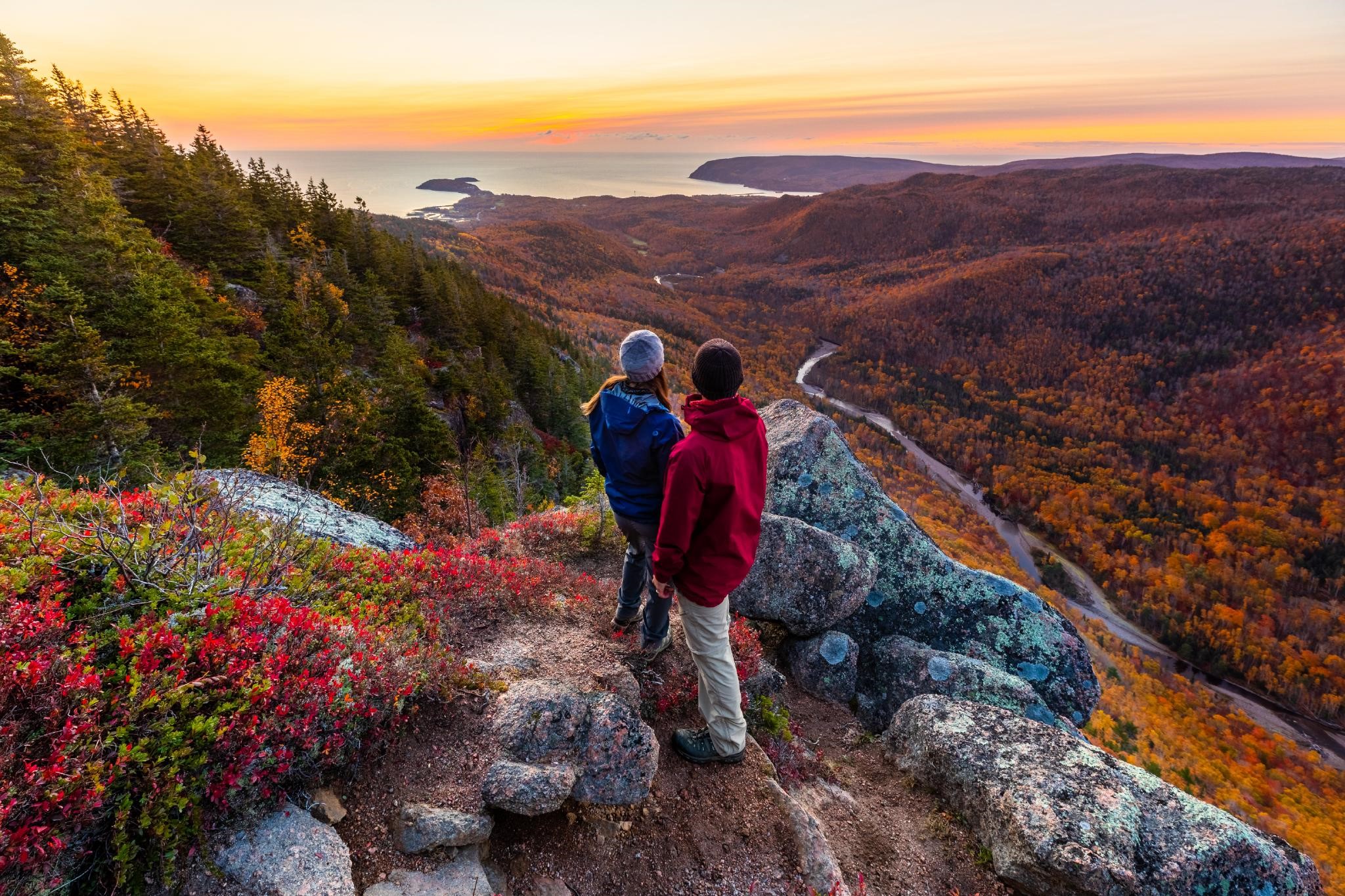 Two people on the Franey Trail look out over the ocean. 