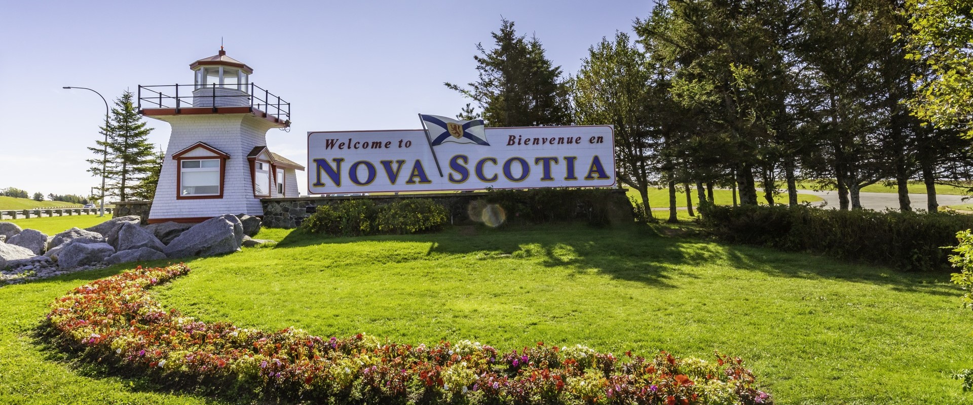 A photo of the lighthouse and Nova Scotia sign on the lawn at the Amherst Visitor Information Centre. 