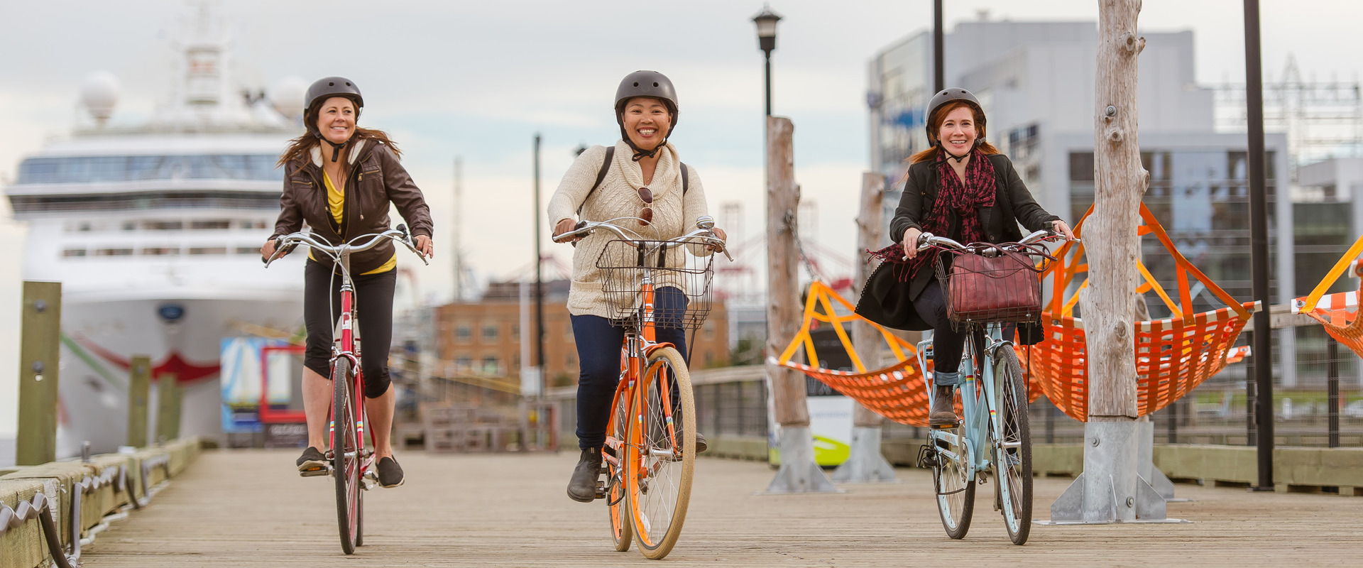 Three people biking on the Halifax Waterfront.