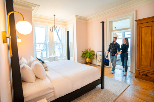 Guests arrive to a sunny guestroom at The August House. 