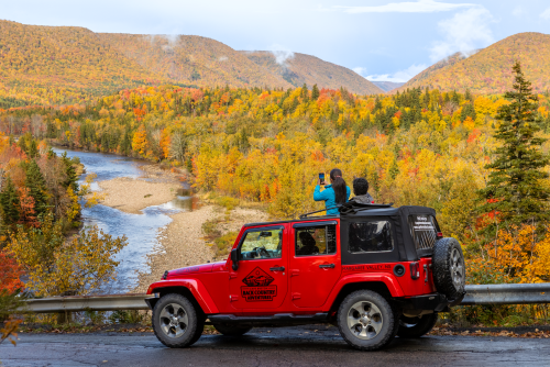 Guests take a picture of the fall foliage with Cape Breton Backcountry Adventures