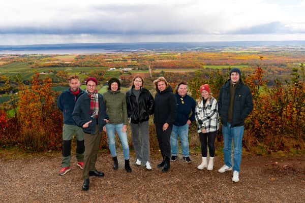 A group of people standing together enjoying the lookoff at Blomidon. 