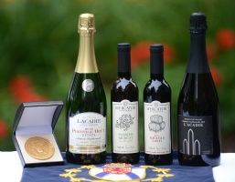 Image of four Nova Scotia wine bottles beside the Lt. Governor's Award of Excellence medal.
