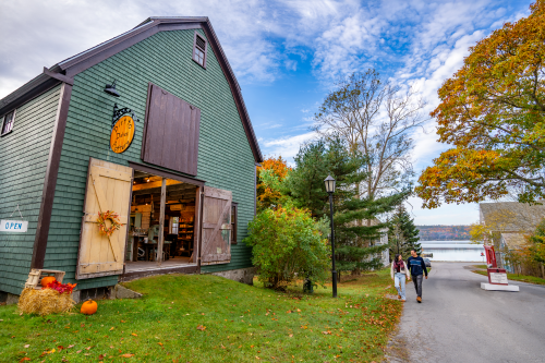 The outside of the Dirt To Dishes Pottery studio. It is a green wooden building. 