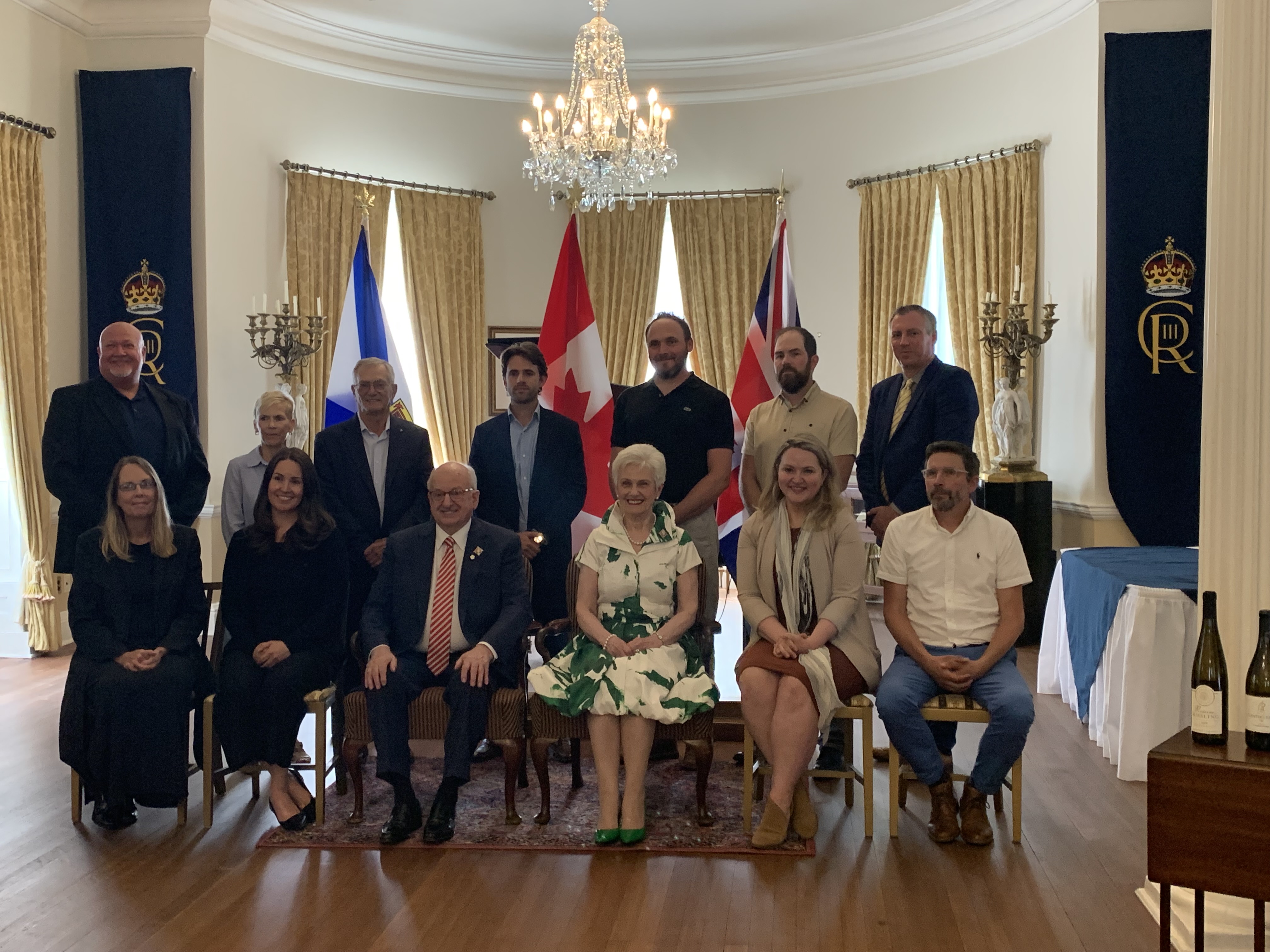 The winners of the Lieutenant Governor's Award for Excellence in Nova Scotia Wines are pictured standing and seated around the Lieutenant Governor and his wife Patsy. 