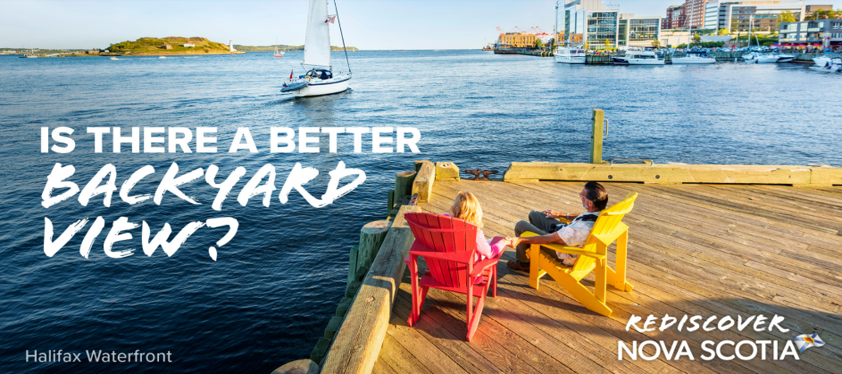 Image of people sitting on chairs by the Halifax waterfront as a sailboat passes. Text reads: Is there a better backyard view?