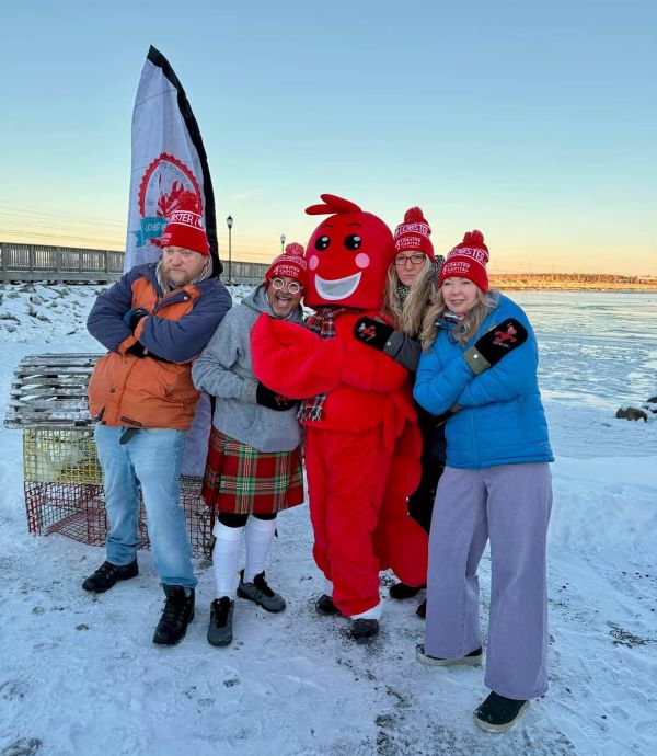 Travel media guests pictured with Lucy the Lobstar mascot during the Lobster Crawl. 