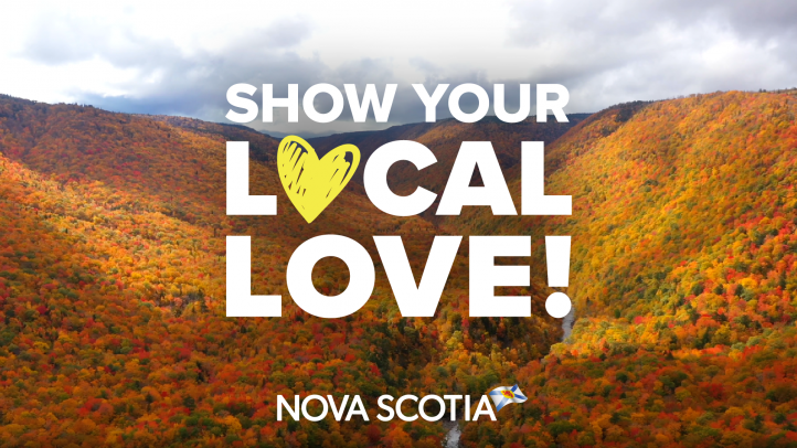 Vibrant fall foliage in the Cape Breton Highlands with Show Your Local Love logo.