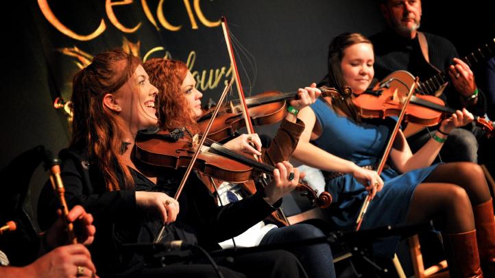 Musicians playing fiddles at Celtic Colours International Festival.