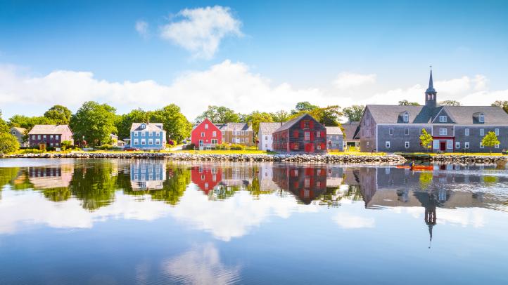 Historic Shelburne waterfront reflected on the water. 