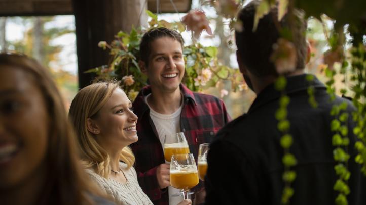 A group celebrates a toast at Trout Point Lodge in Kemptville.