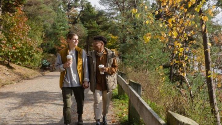 Two people holding hands as they walk through Point Pleasant Park