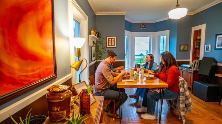 Four people sitting at a table eating in the Wild Caraway Restaurant in Bridgewater. 