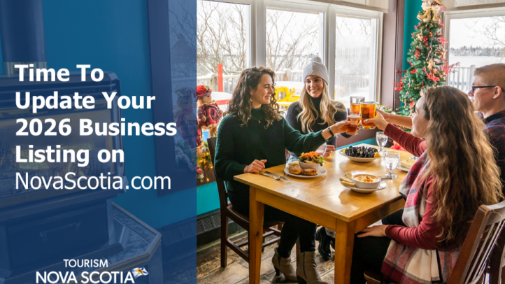 A group of four people sitting at a table saying 'Cheers". 