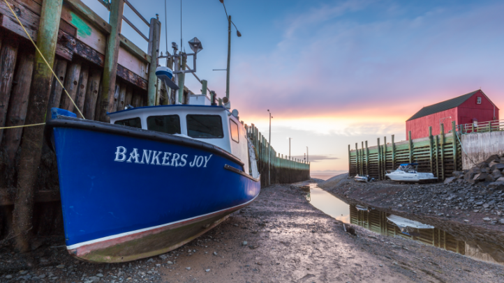 Fishing boat sitting on the seabed in Hall's Harbour. 