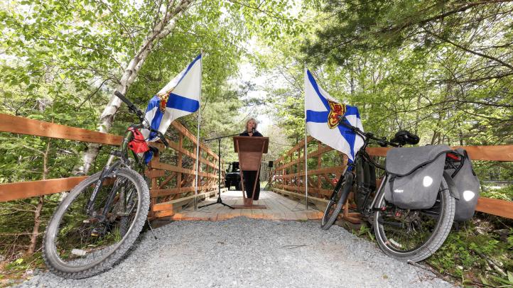 Minister Masland makes an announcement from a trail in Queens County. 