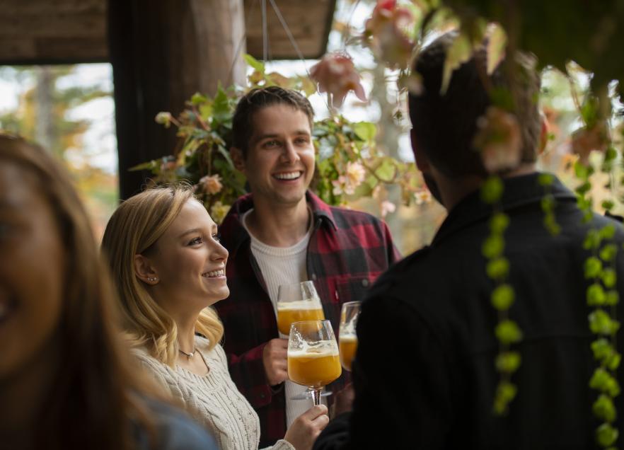 A group celebrates a toast at Trout Point Lodge in Kemptville.