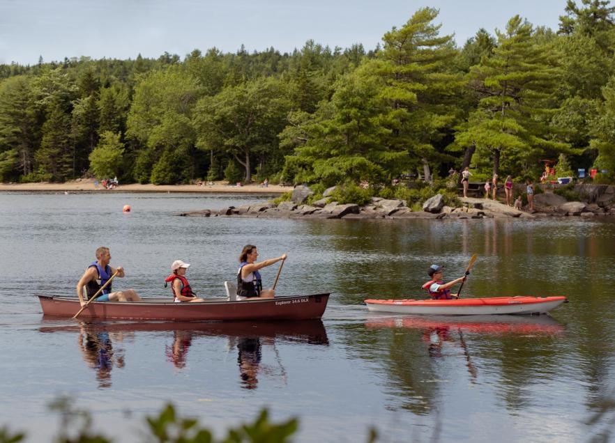 A family enjoying a canoeing and kayaking experience at Dollar Lake Provincial Park