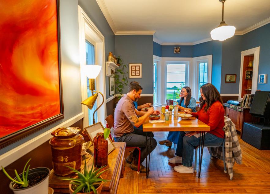 Four people sitting at a table eating in the Wild Caraway Restaurant in Bridgewater. 