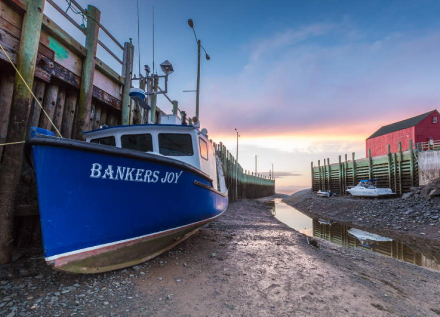 Fishing boat sitting on the seabed in Hall's Harbour. 