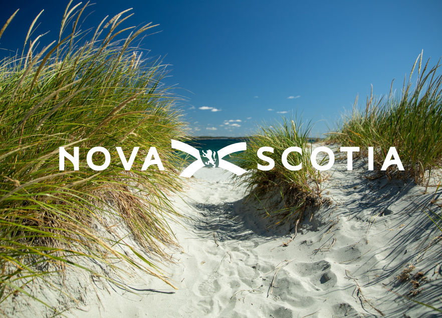 A path through a dune to the beach with a Nova Scotia logo over it. 