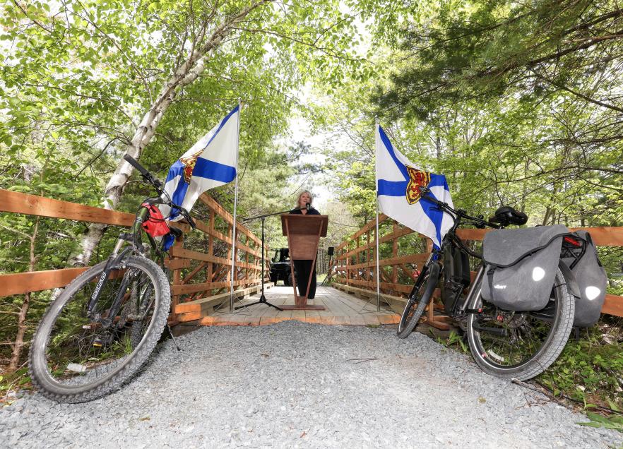 Minister Masland makes an announcement from a trail in Queens County. 