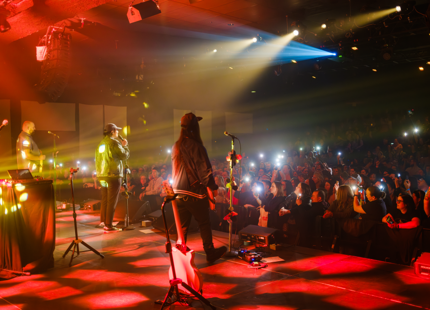 Rita Mae performing on stage at the Lighthouse Arts Centre. 