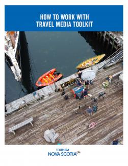 How to Work with Travel Media Toolkit Cover. Image of cameras set up on a dock with kayaks in the water.