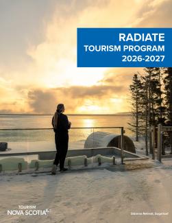 A woman standing back to looking at the sunset